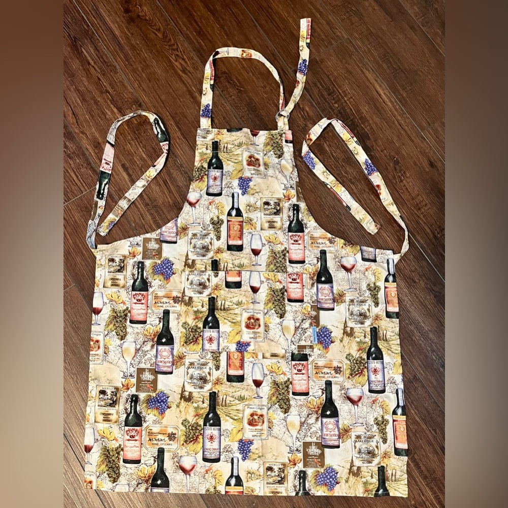 NWOT now designs adult apron.  Wine bottle print. Adjustable neck strap. Unisex.